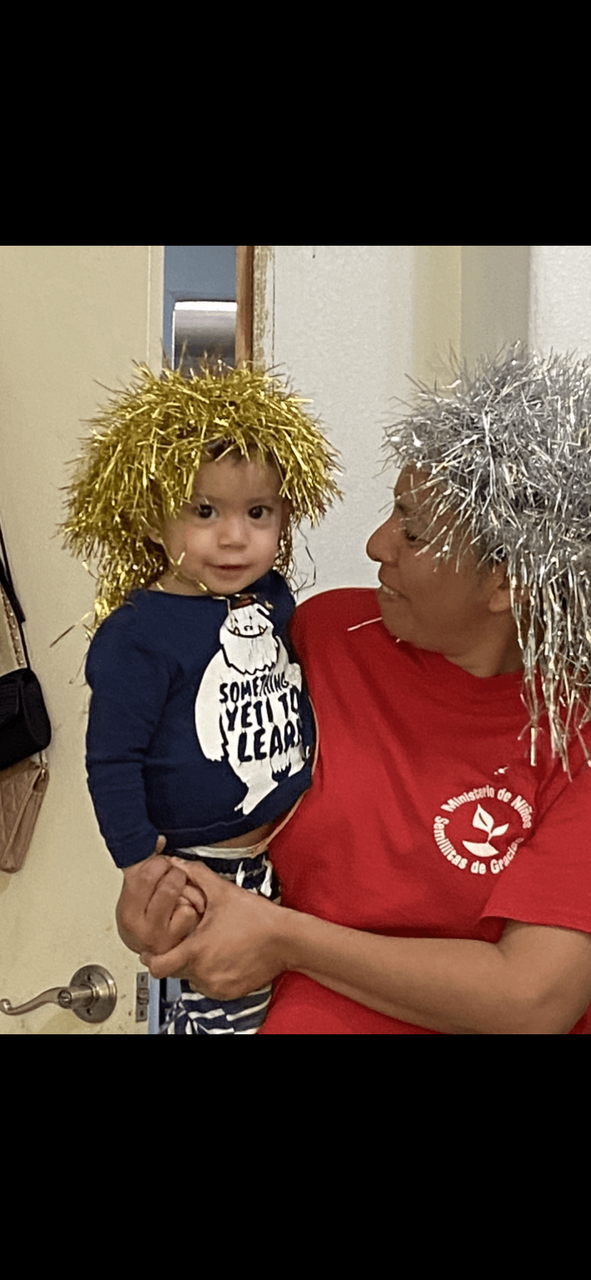 Mother and baby wearing crazy wigs.