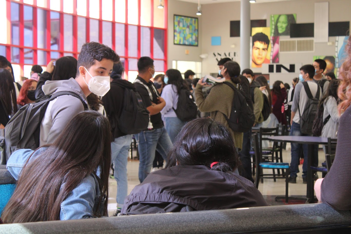 Students talk while waiting for buses.