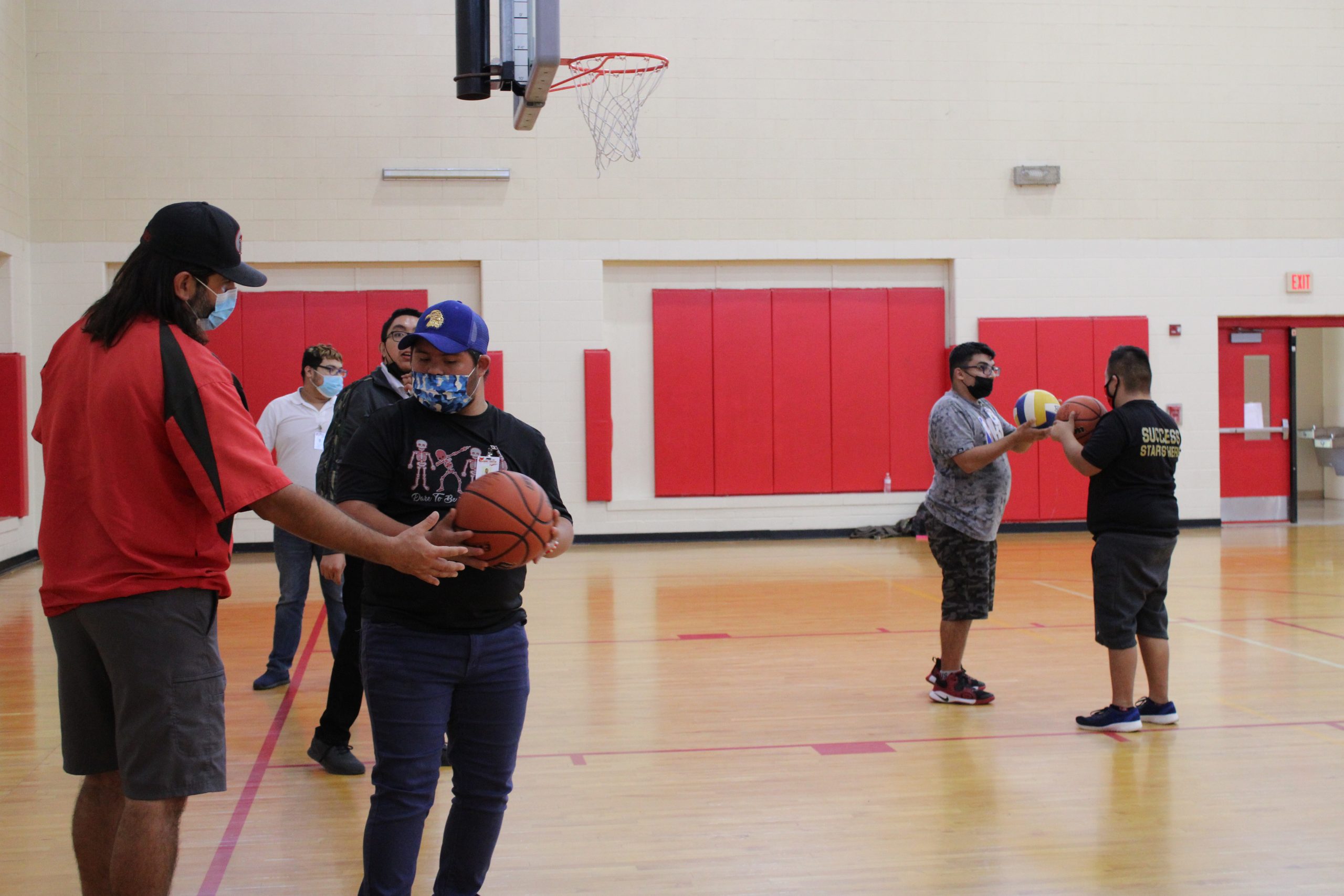 Coach helping care academy students