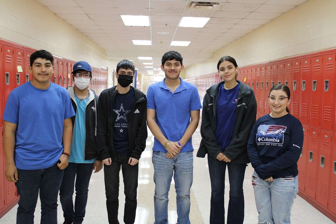 Six students wearing blue outfits.