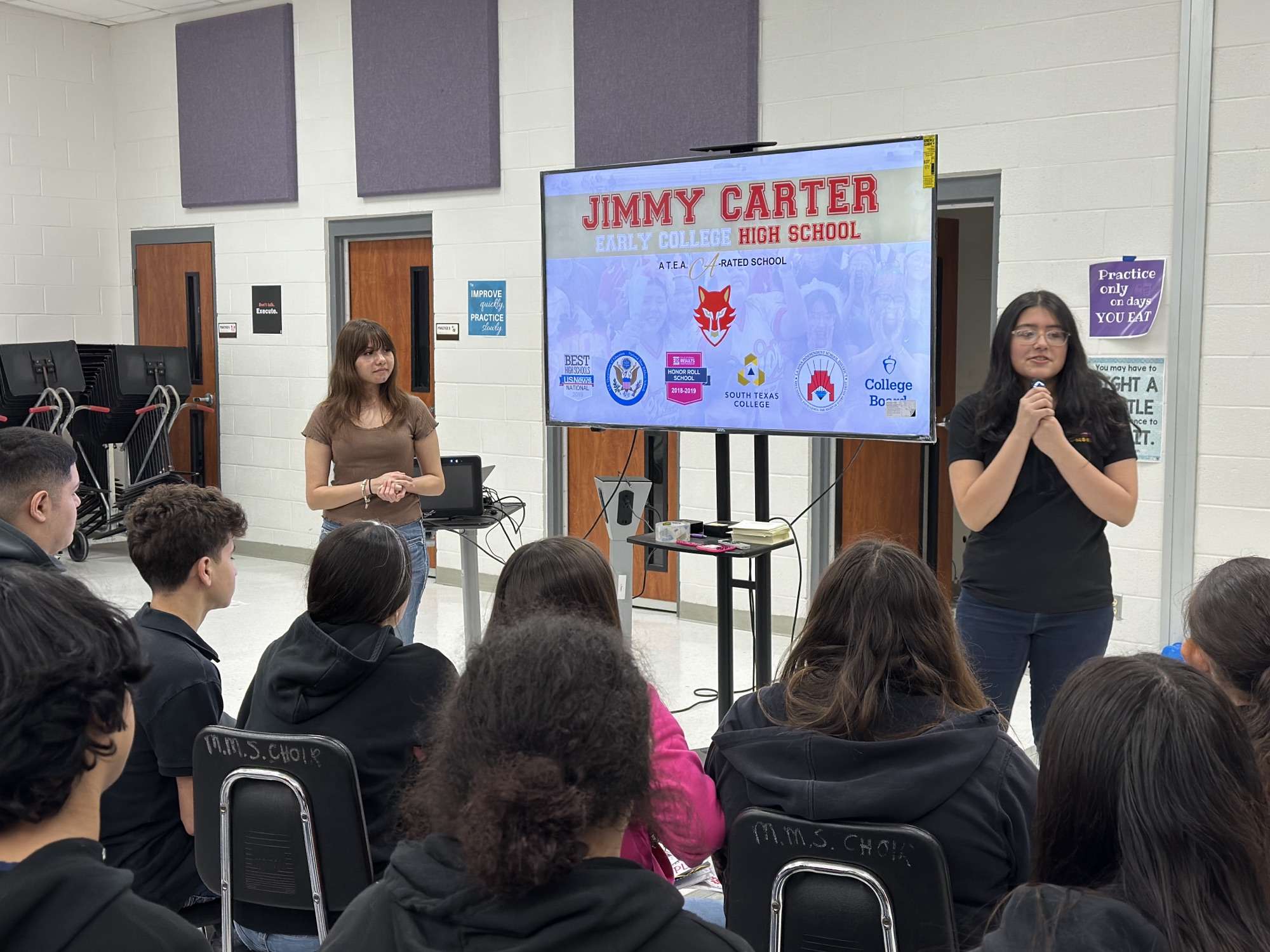 RedWolves Luz Morado and Camilla Garza talking to eighth graders at
